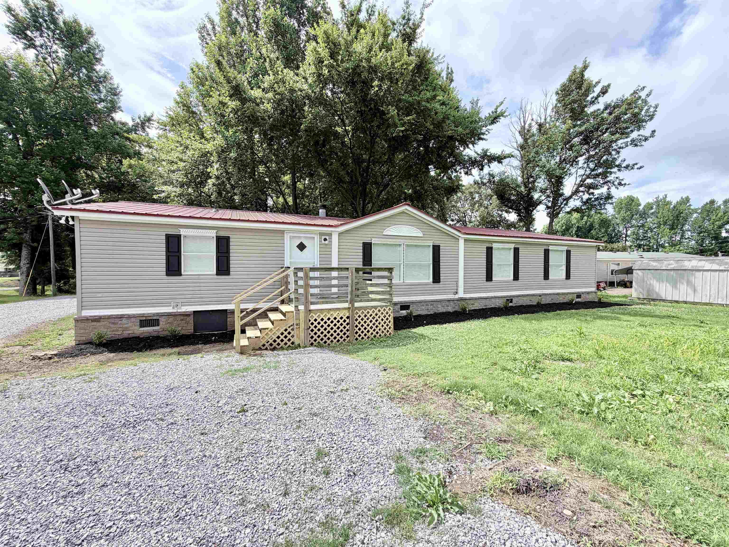 1655 Fayne Road Brighton, TN 38011 - Photo 2 of 28 Ranch-style residence featuring light gray siding, a red metal roof, and dark shutters