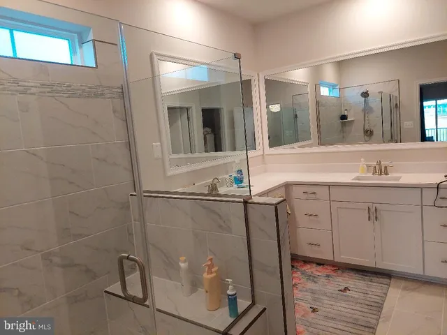 a bathroom with a granite countertop sink mirror and vanity