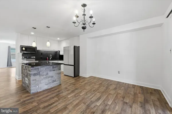 a view of kitchen with sink microwave and refrigerator