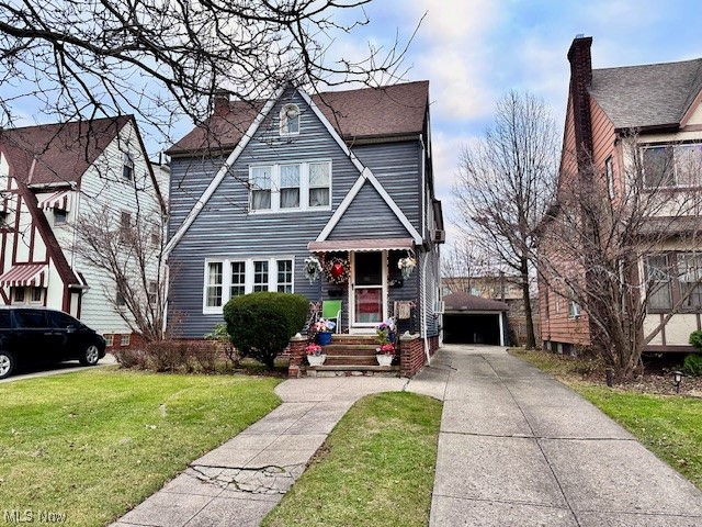 801 Hoover Road Cleveland, OH 44119 - Photo 1 of 24 Tudor home featuring a front yard and a garage