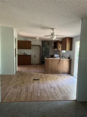 a view of a room with wooden floor and chair