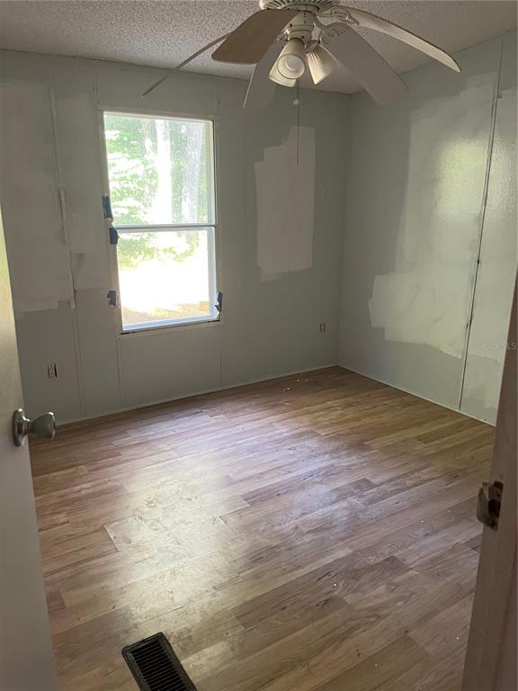 1130 Southwest 133rd Ave Road Ocala, FL 34481 - Photo 24 of 24 an empty room with wooden floor and windows