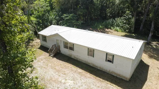 a view of a backyard with mountain view and wooden floor