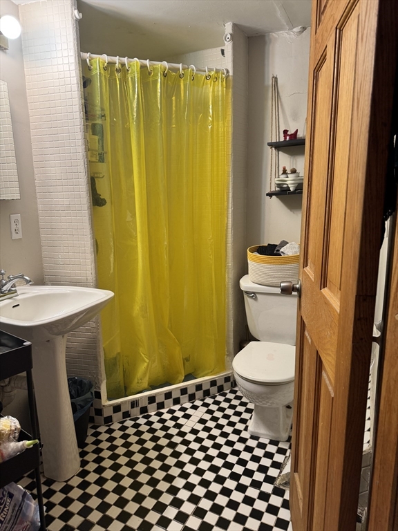 11 Savin Hill Avenue Boston, MA 02125 - Photo 11 of 40 a bathroom with a sink and a toilet