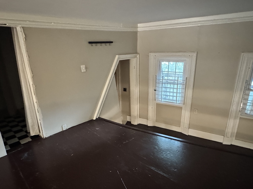 11 Savin Hill Avenue Boston, MA 02125 - Photo 26 of 40 an empty room with wooden floor and a window