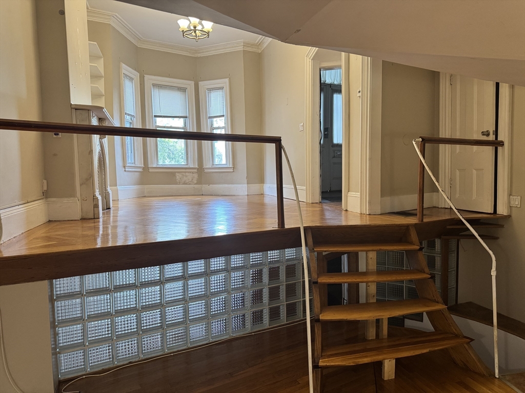 11 Savin Hill Avenue Boston, MA 02125 - Photo 29 of 40 a view of staircase with wooden floor and windows
