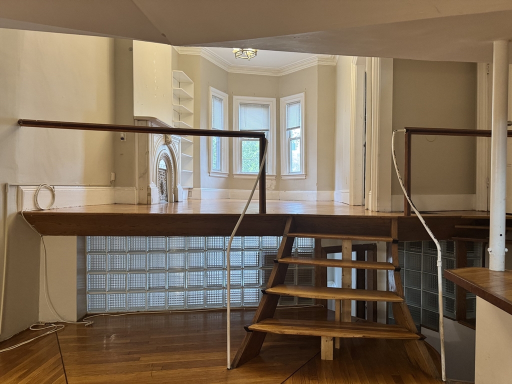 11 Savin Hill Avenue Boston, MA 02125 - Photo 32 of 40 a view of staircase with white walls and a window