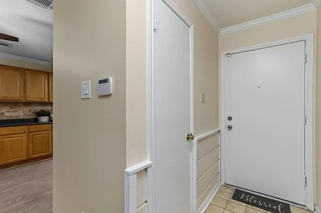 a view of a kitchen with white cabinets and wooden floor