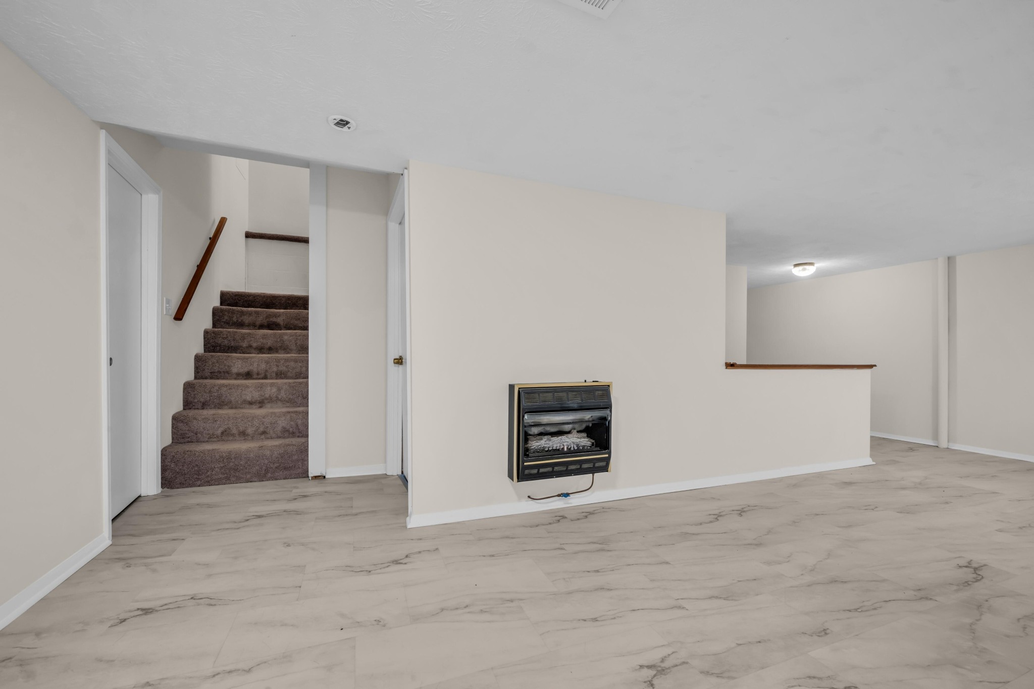 218 Quail Court Dickson, TN 37055 - Photo 17 of 22 an empty room with a hallway and stairs