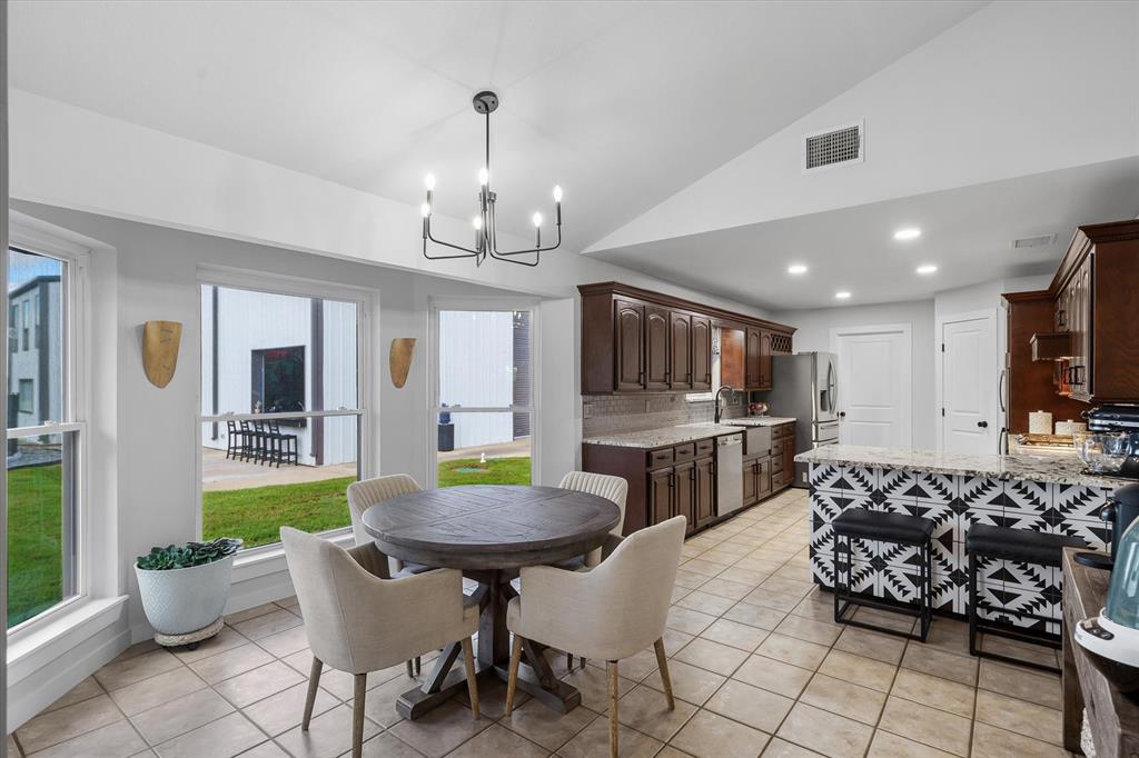 9346 Homestead Lane Forney, TX 75126 - Photo 6 of 39 The beautifully appointed kitchen and dining area look out to the pool area.