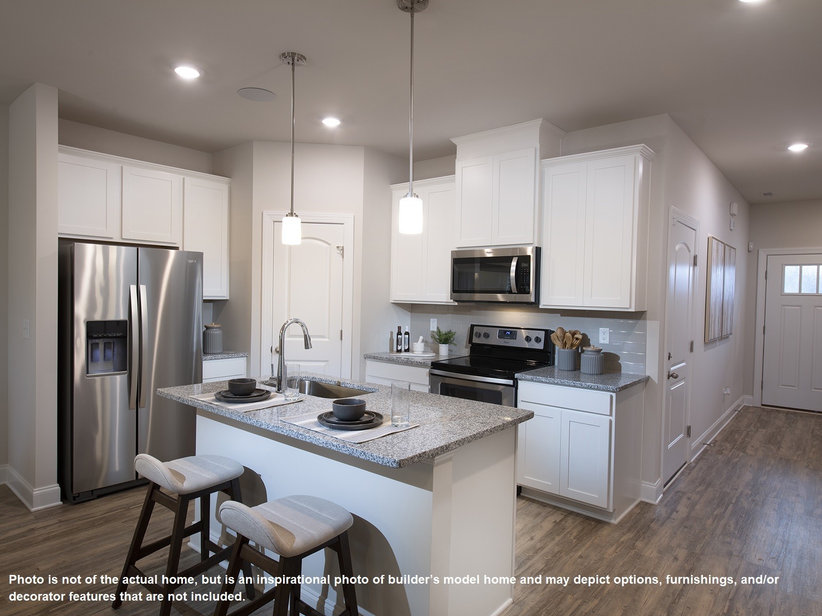 1364 Vilda Way Lebanon, TN 37087 - Photo 3 of 15 a kitchen with stainless steel appliances kitchen island granite countertop a sink refrigerator and microwave