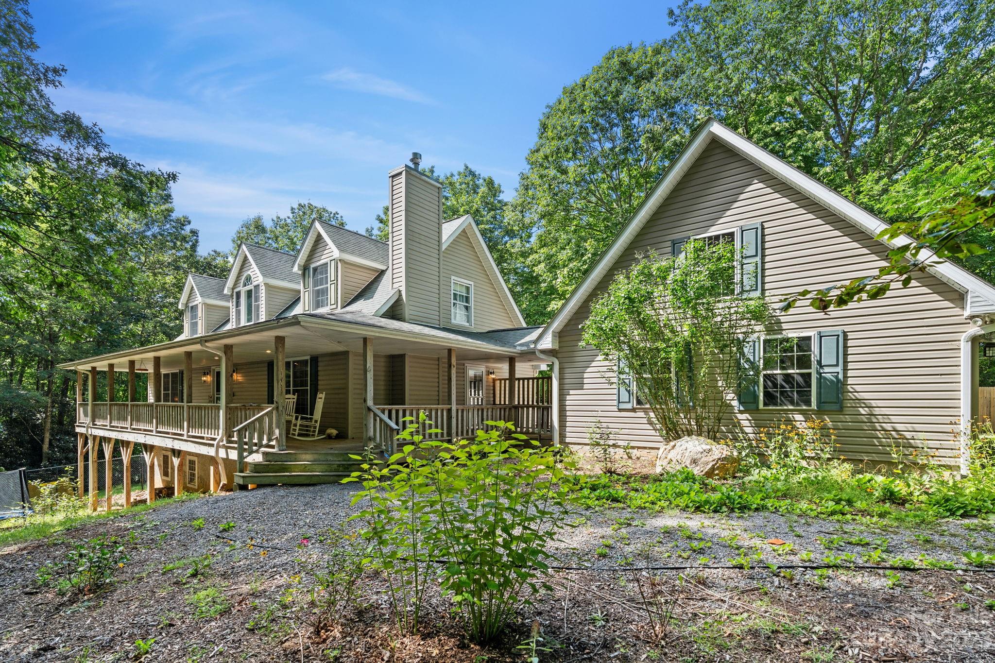 a front view of a house with a yard and potted plants