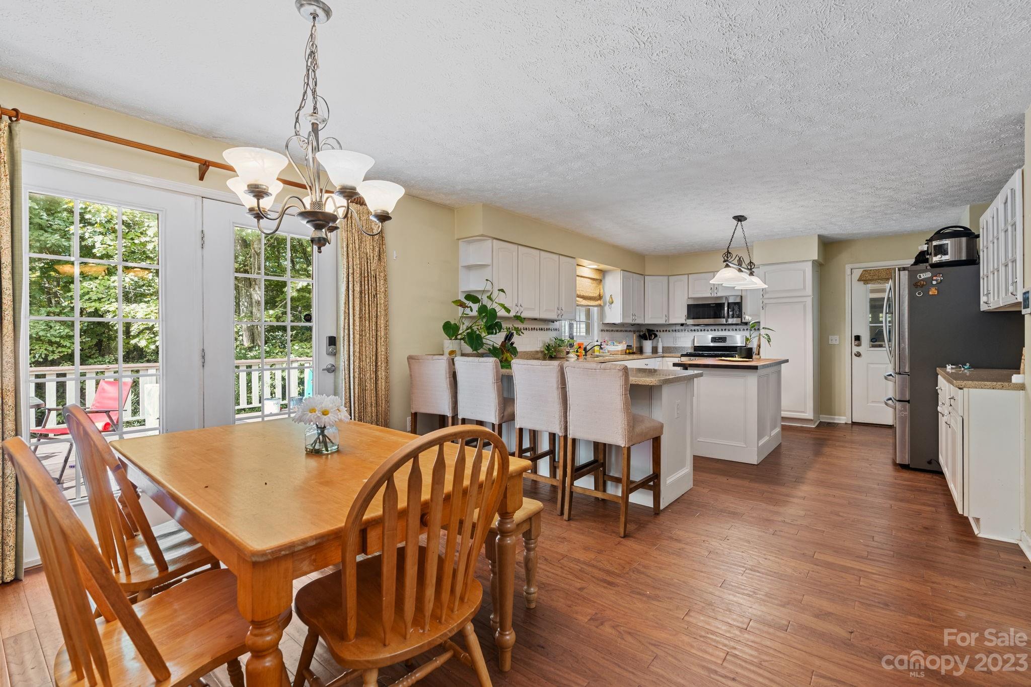 42 Bear Trail Fairview, NC 28730 - Photo 11 of 37 a view of a dining room with furniture large window and wooden floor