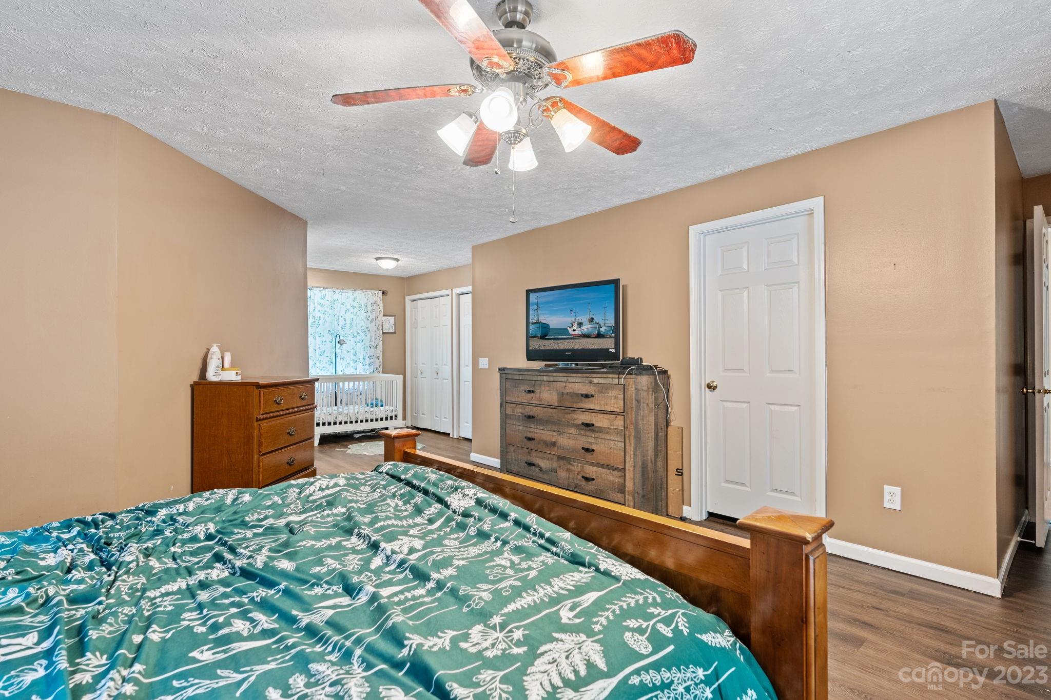 42 Bear Trail Fairview, NC 28730 - Photo 16 of 37 a bedroom with a bed and a flat screen tv