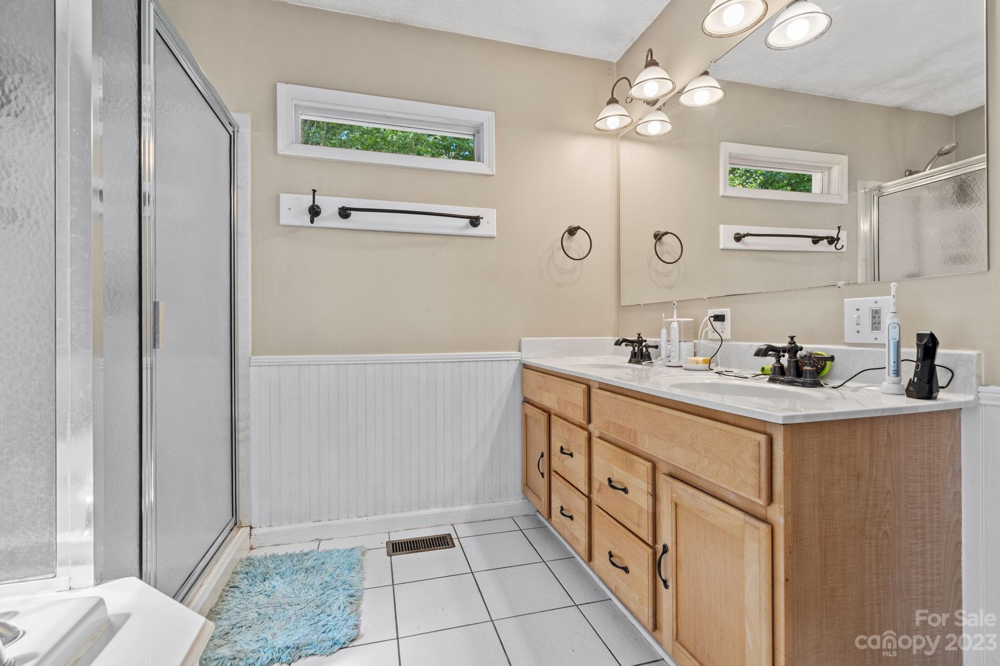 42 Bear Trail Fairview, NC 28730 - Photo 17 of 37 a bathroom with a sink a vanity and a mirror