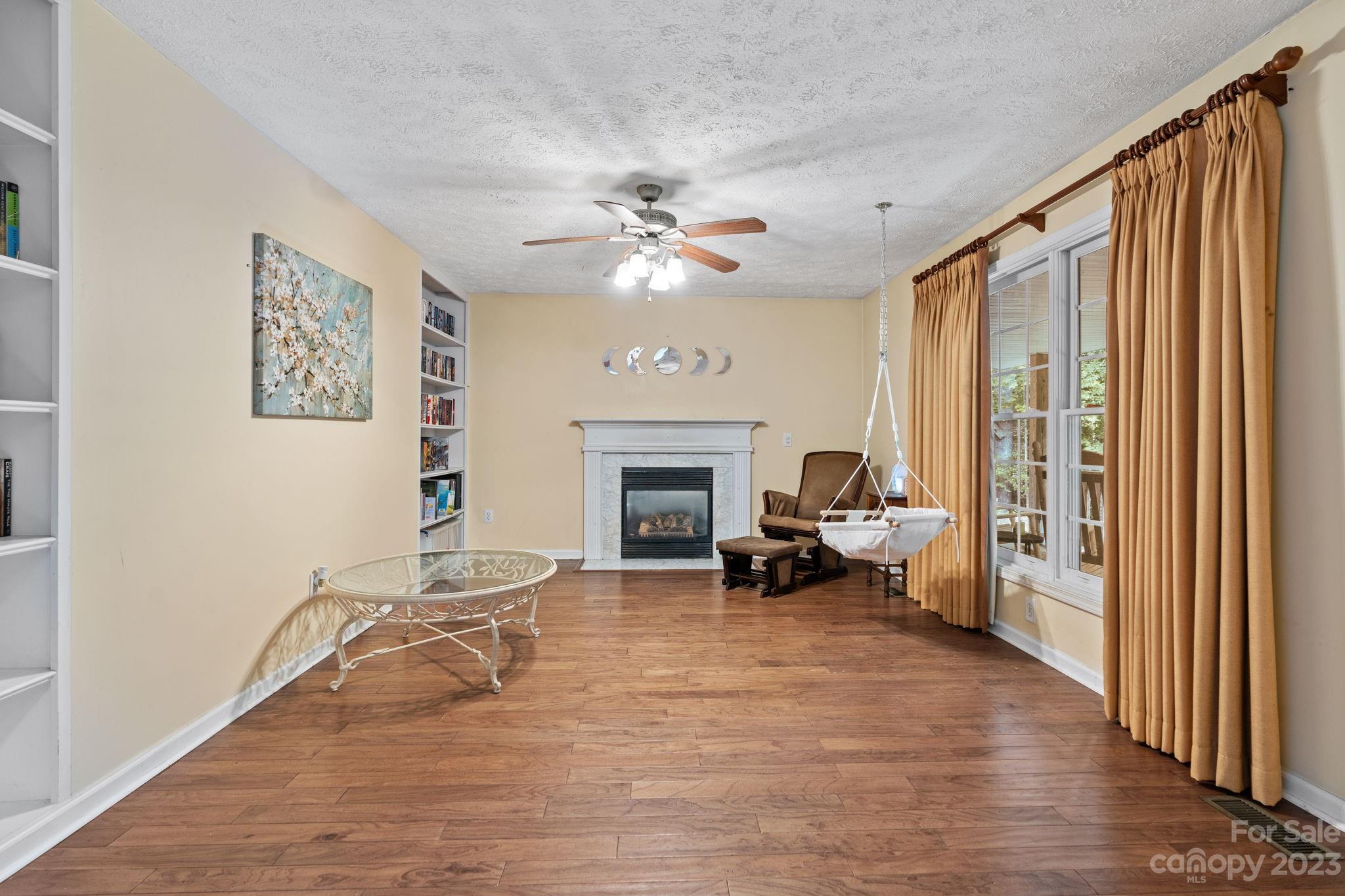 42 Bear Trail Fairview, NC 28730 - Photo 19 of 37 a living room with furniture and a fireplace