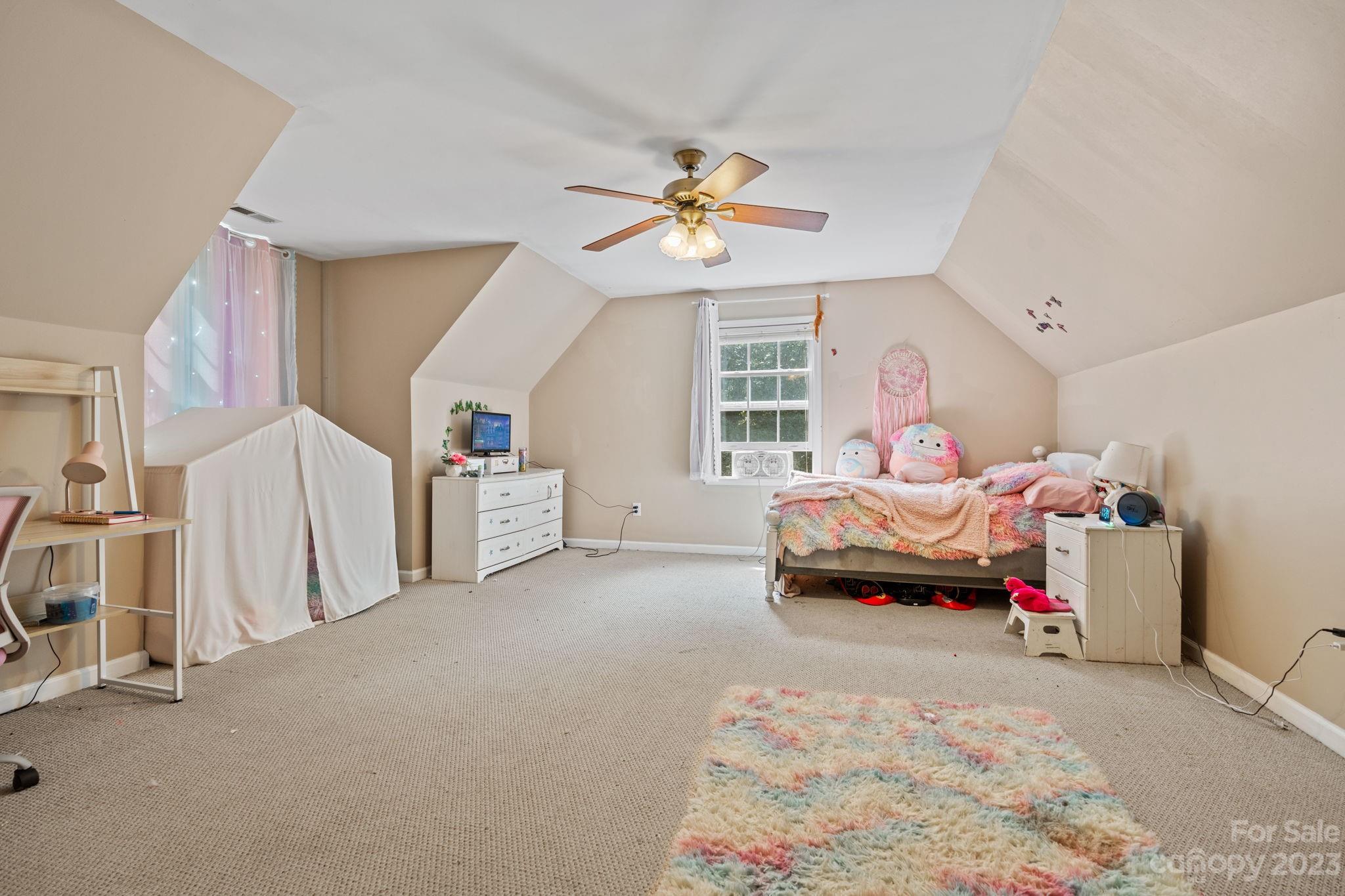 42 Bear Trail Fairview, NC 28730 - Photo 22 of 37 a bedroom with furniture and a chandelier