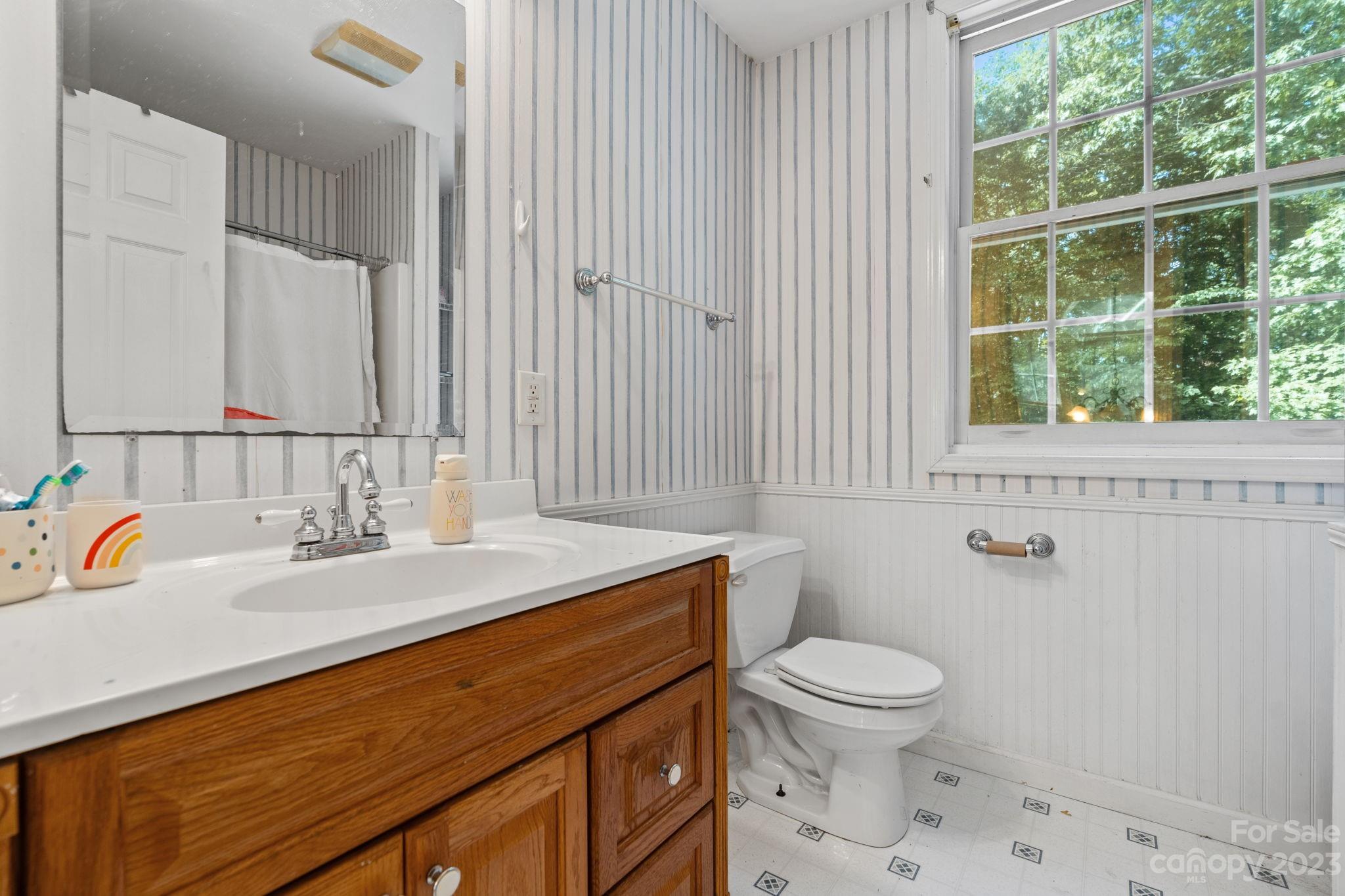 42 Bear Trail Fairview, NC 28730 - Photo 26 of 37 a bathroom with a sink a toilet and a window