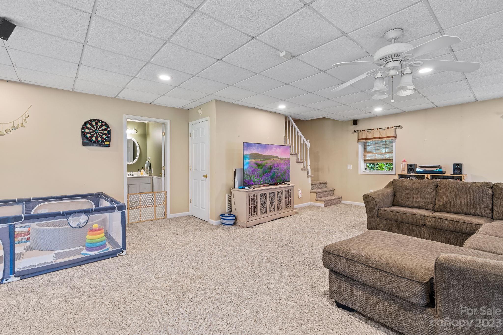 42 Bear Trail Fairview, NC 28730 - Photo 28 of 37 a living room with furniture and a flat screen tv
