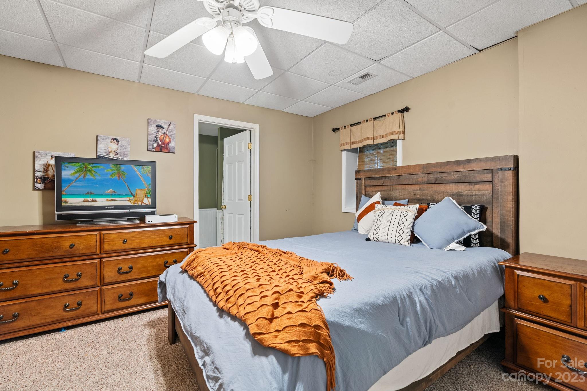 42 Bear Trail Fairview, NC 28730 - Photo 30 of 37 a bedroom with a bed and a tv on the dresser