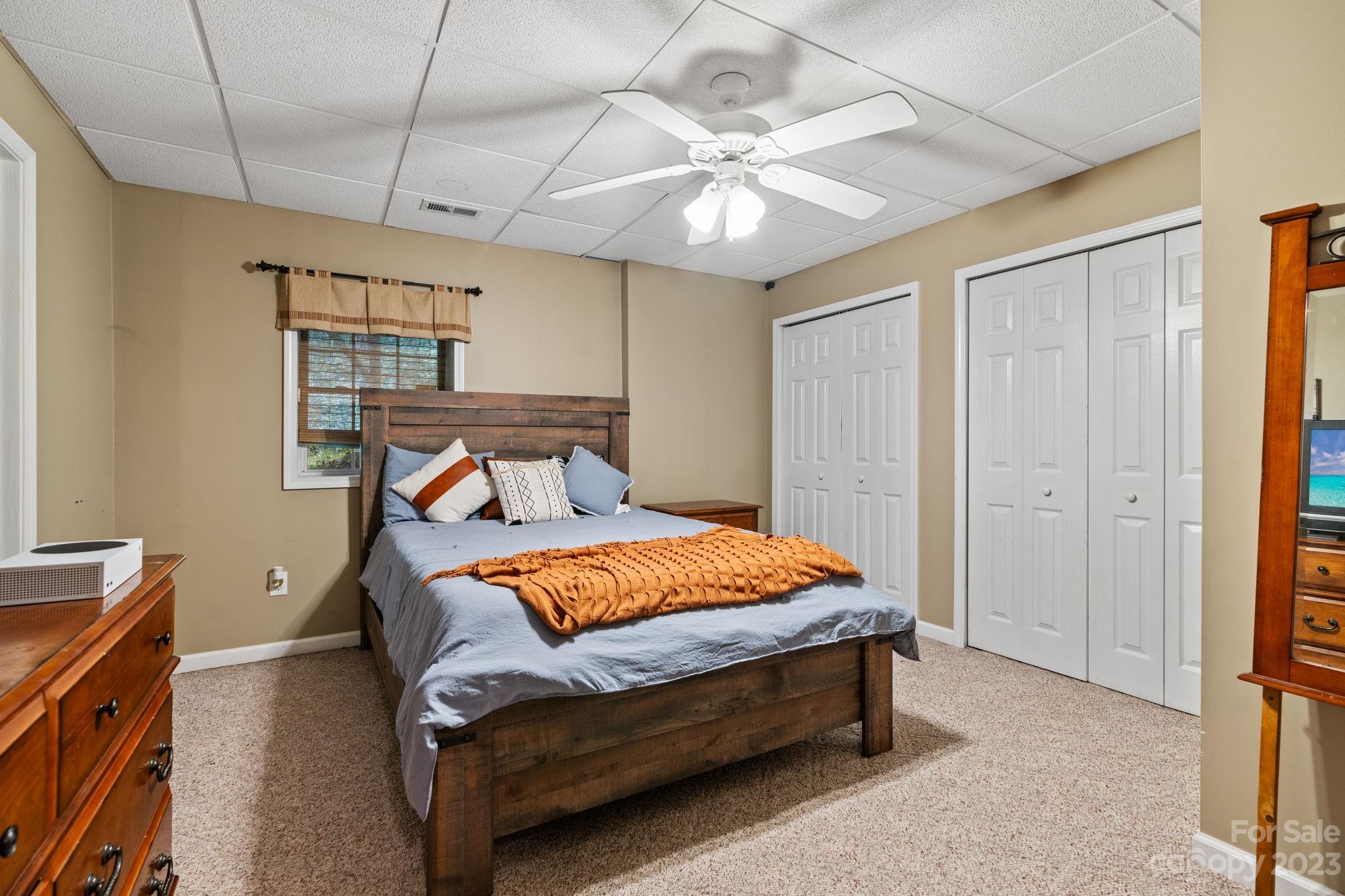 42 Bear Trail Fairview, NC 28730 - Photo 31 of 37 a bedroom with a bed and a chandelier
