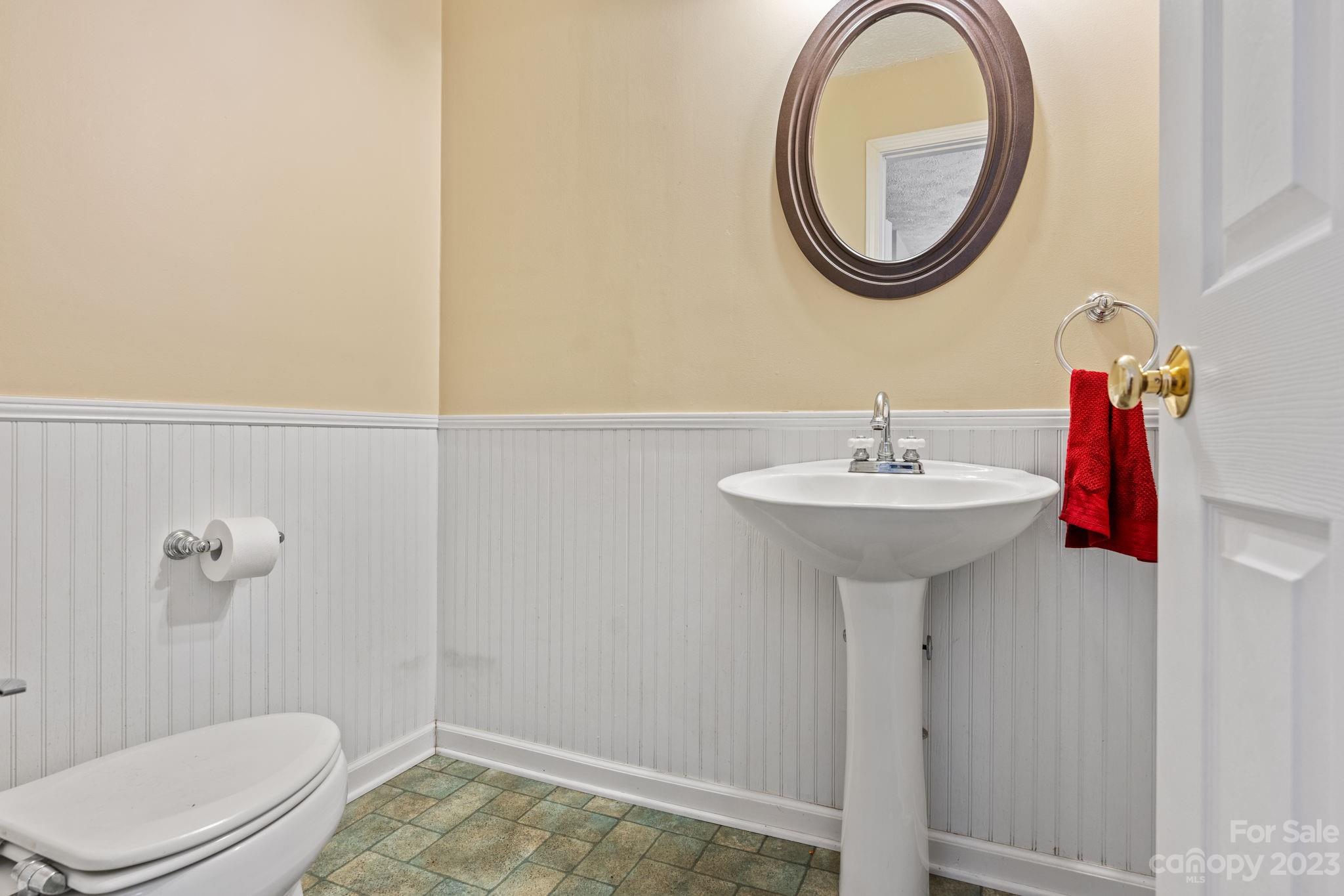 42 Bear Trail Fairview, NC 28730 - Photo 37 of 37 a bathroom with a sink a toilet and a mirror