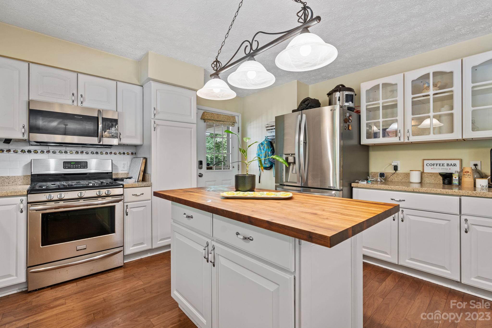 42 Bear Trail Fairview, NC 28730 - Photo 8 of 37 a kitchen with stainless steel appliances granite countertop a stove a sink and a refrigerator