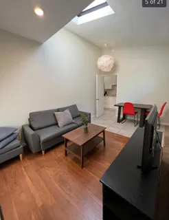 a living room with furniture and a chandelier