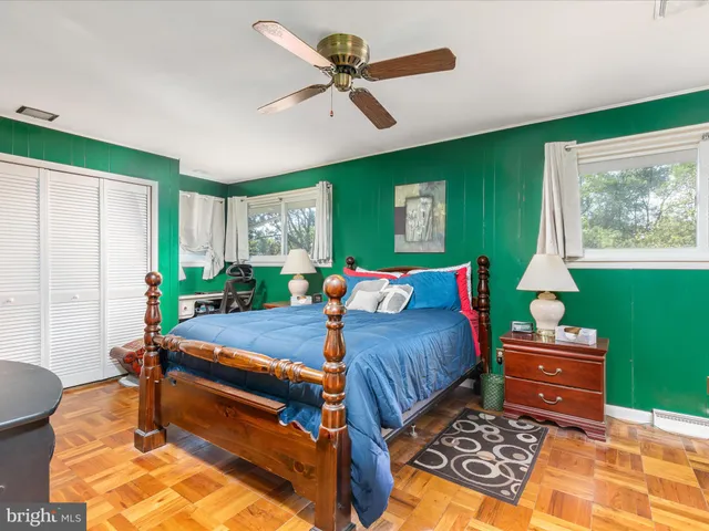 a bedroom with a bed a desk and chair