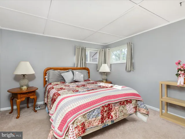 a bathroom with a toilet a sink and a shower curtain
