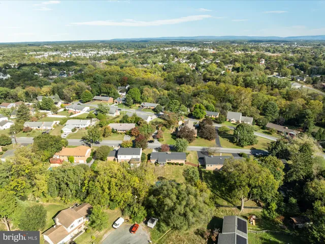 a view of a backyard with swimming pool