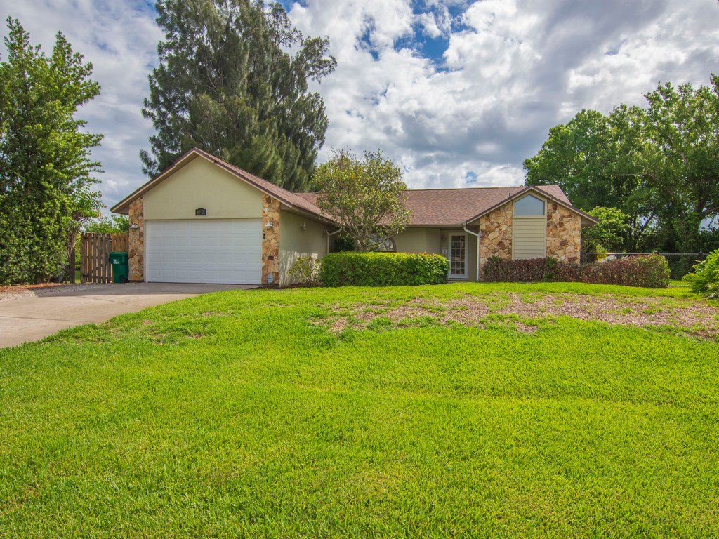 a front view of house with yard and green space