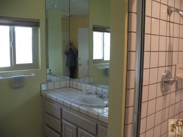 67145 San Ardo Road Desert Hot Springs, CA 92240 - Photo 12 of 20 a bathroom with a granite countertop sink and a mirror