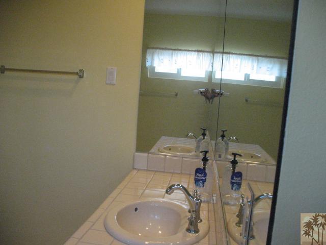 67145 San Ardo Road Desert Hot Springs, CA 92240 - Photo 17 of 20 a bathroom with a sink a toilet and shower