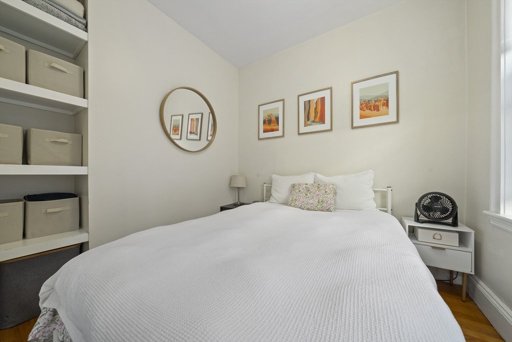 74 Fenway, Unit 35 Boston, MA 02115 - Photo 13 of 15 a bedroom with a bed and a table