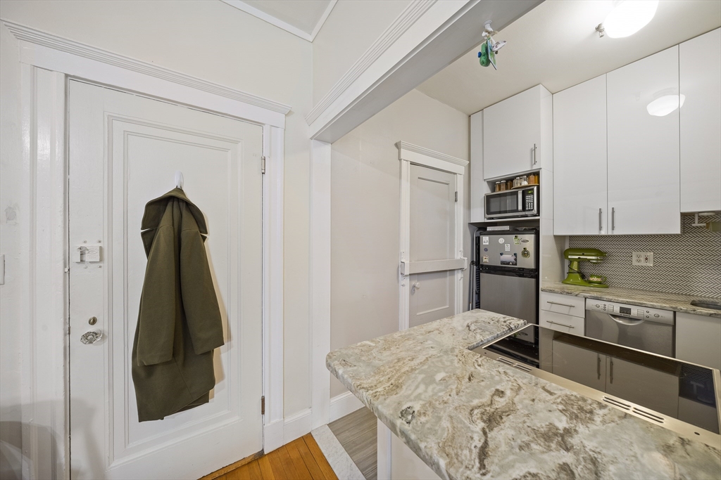 74 Fenway, Unit 35 Boston, MA 02115 - Photo 5 of 15 a kitchen with stainless steel appliances granite countertop a refrigerator sink and stove