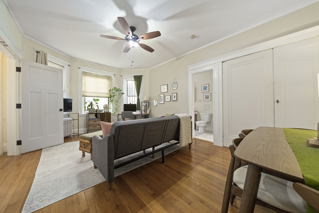 74 Fenway, Unit 35 Boston, MA 02115 - Photo 8 of 15 a living room with furniture and a chandelier