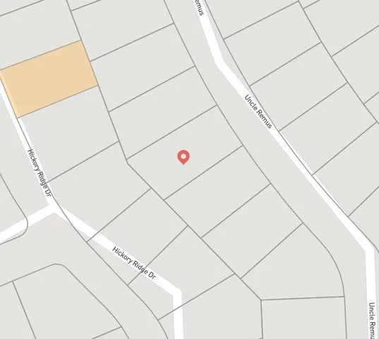 a view of a swimming pool with a garden and trees