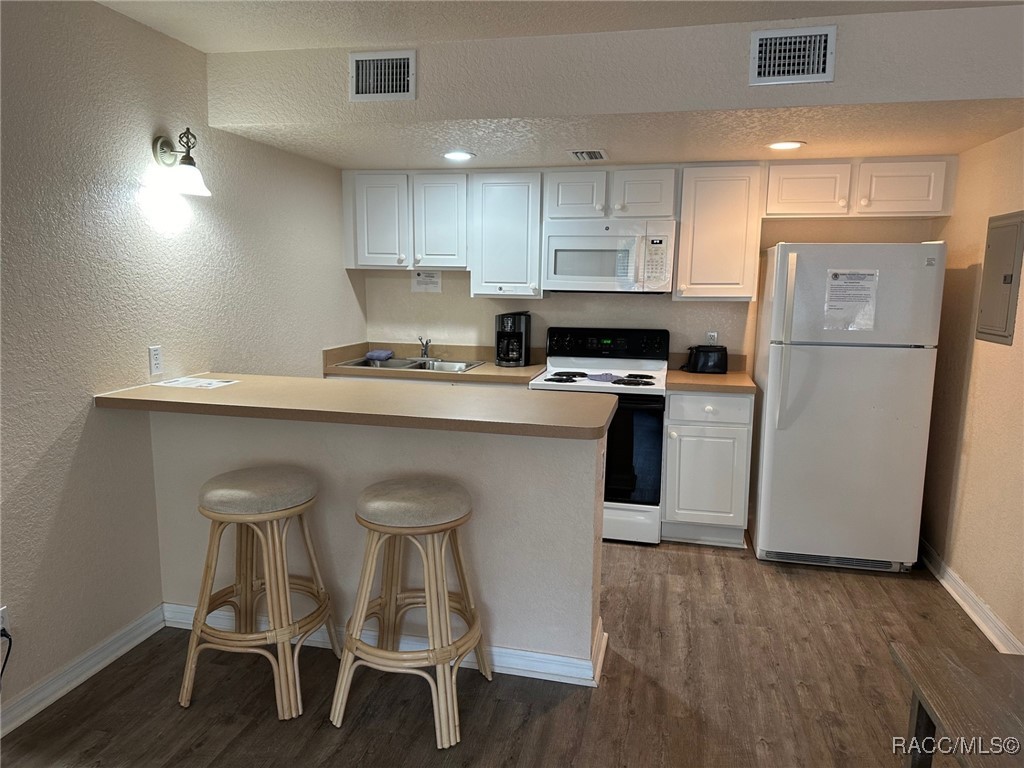 5291 South Cherokee Way Homosassa, FL 34448 - Photo 11 of 27 a kitchen with kitchen island a stove a table and chairs