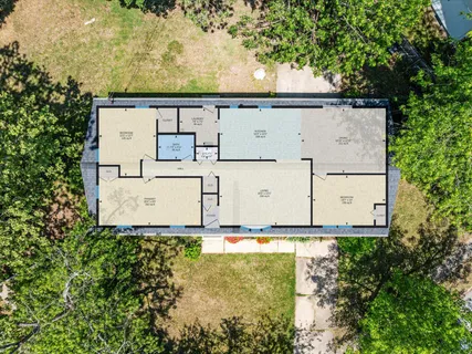 an aerial view of residential house with trees all around