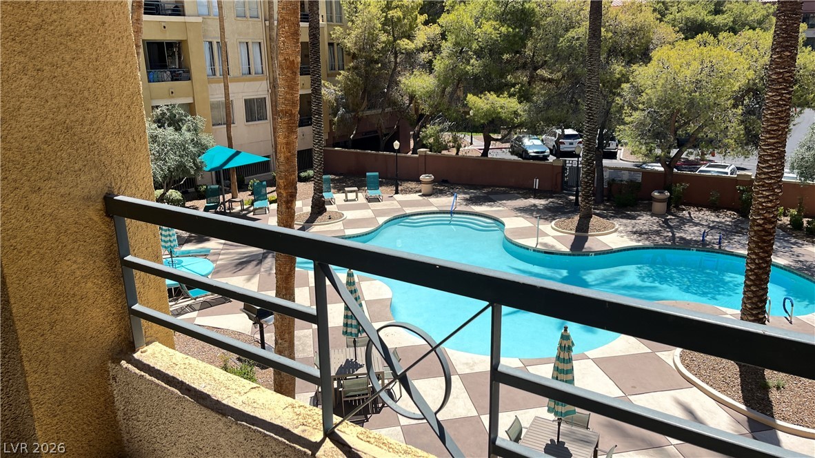 210 East Flamingo Road, Unit 205 Las Vegas, NV 89169 - Photo 2 of 17 Overlook the shimmering community pool from your private balcony, a tranquil oasis in a vibrant setting.