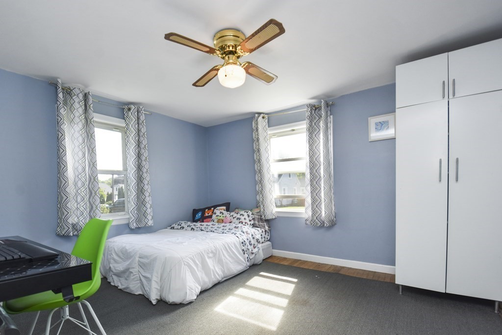 8 Deb Road Woburn, MA 01801 - Photo 12 of 34 a bedroom with a bed and a chandelier