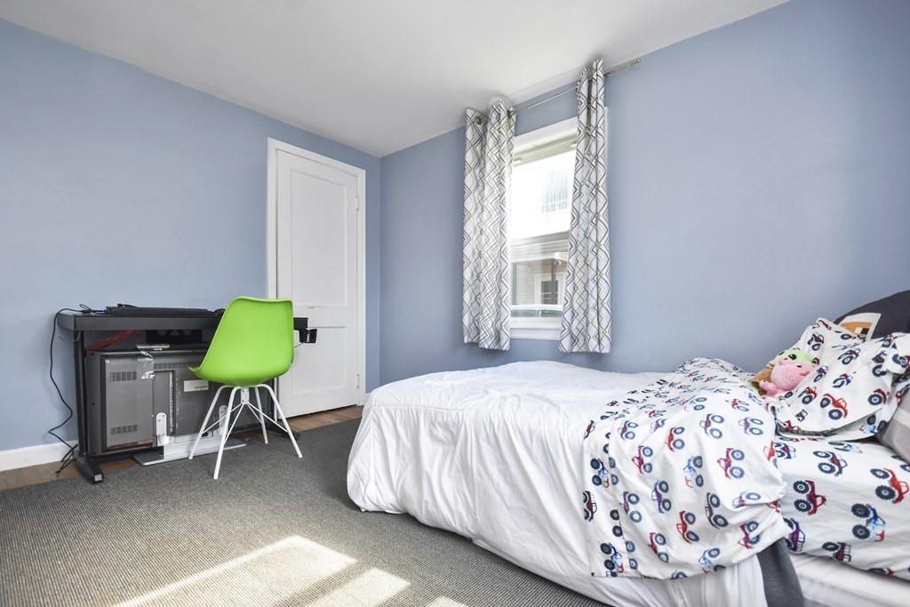 8 Deb Road Woburn, MA 01801 - Photo 13 of 34 a bedroom with a bed and a chair in it