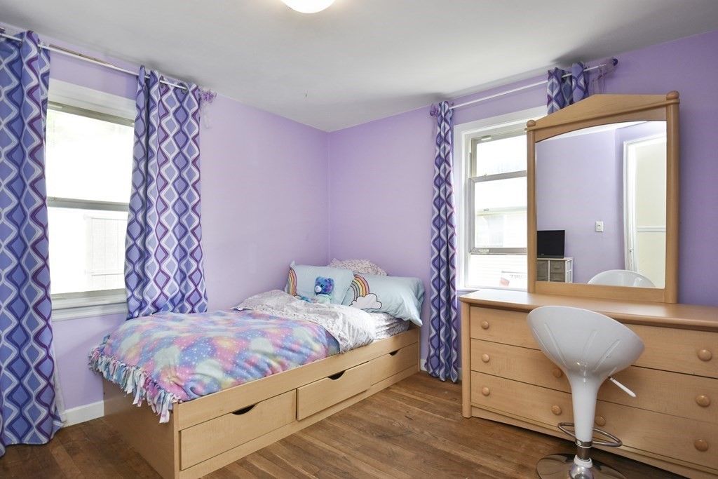 8 Deb Road Woburn, MA 01801 - Photo 14 of 34 a bedroom with a bed and a chandelier