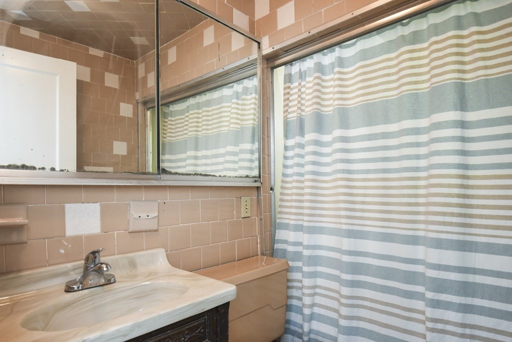 8 Deb Road Woburn, MA 01801 - Photo 16 of 34 a bathroom with a sink and a window