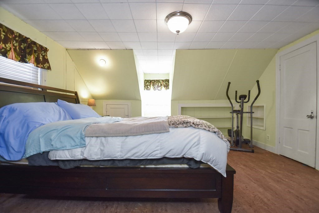 8 Deb Road Woburn, MA 01801 - Photo 20 of 34 a bedroom with a bed and painting on the wall