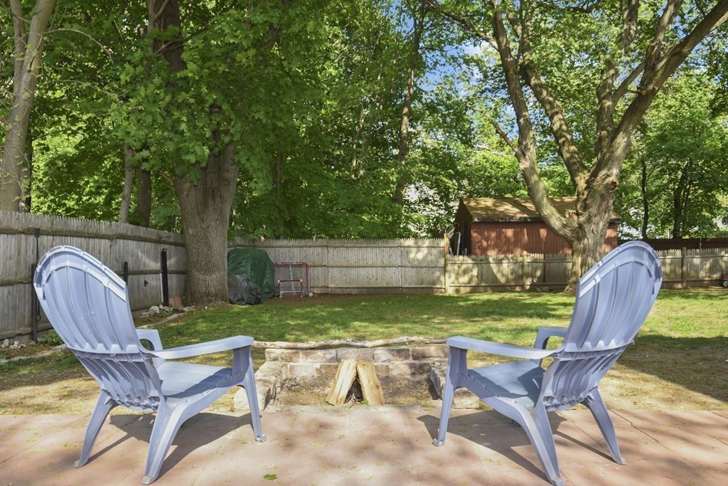 8 Deb Road Woburn, MA 01801 - Photo 30 of 34 a view of backyard with table and chairs and a large tree