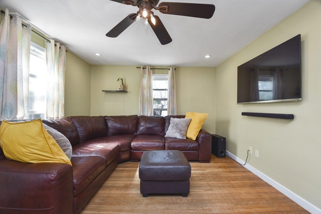 8 Deb Road Woburn, MA 01801 - Photo 8 of 34 a living room with furniture and a flat screen tv