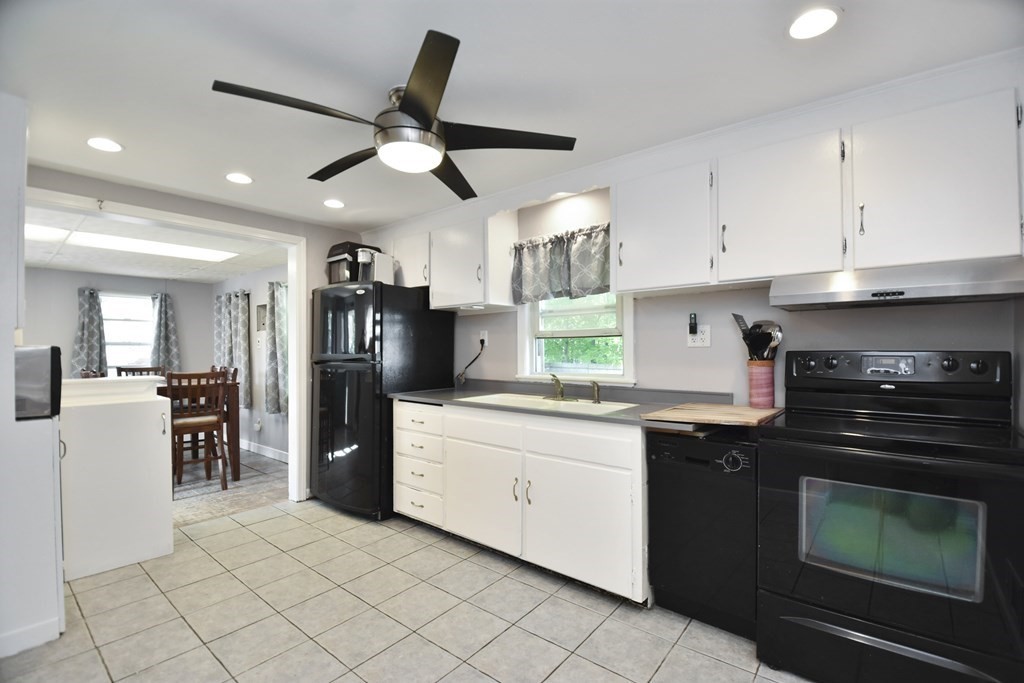 8 Deb Road Woburn, MA 01801 - Photo 9 of 34 a kitchen with granite countertop a refrigerator stove top oven and sink
