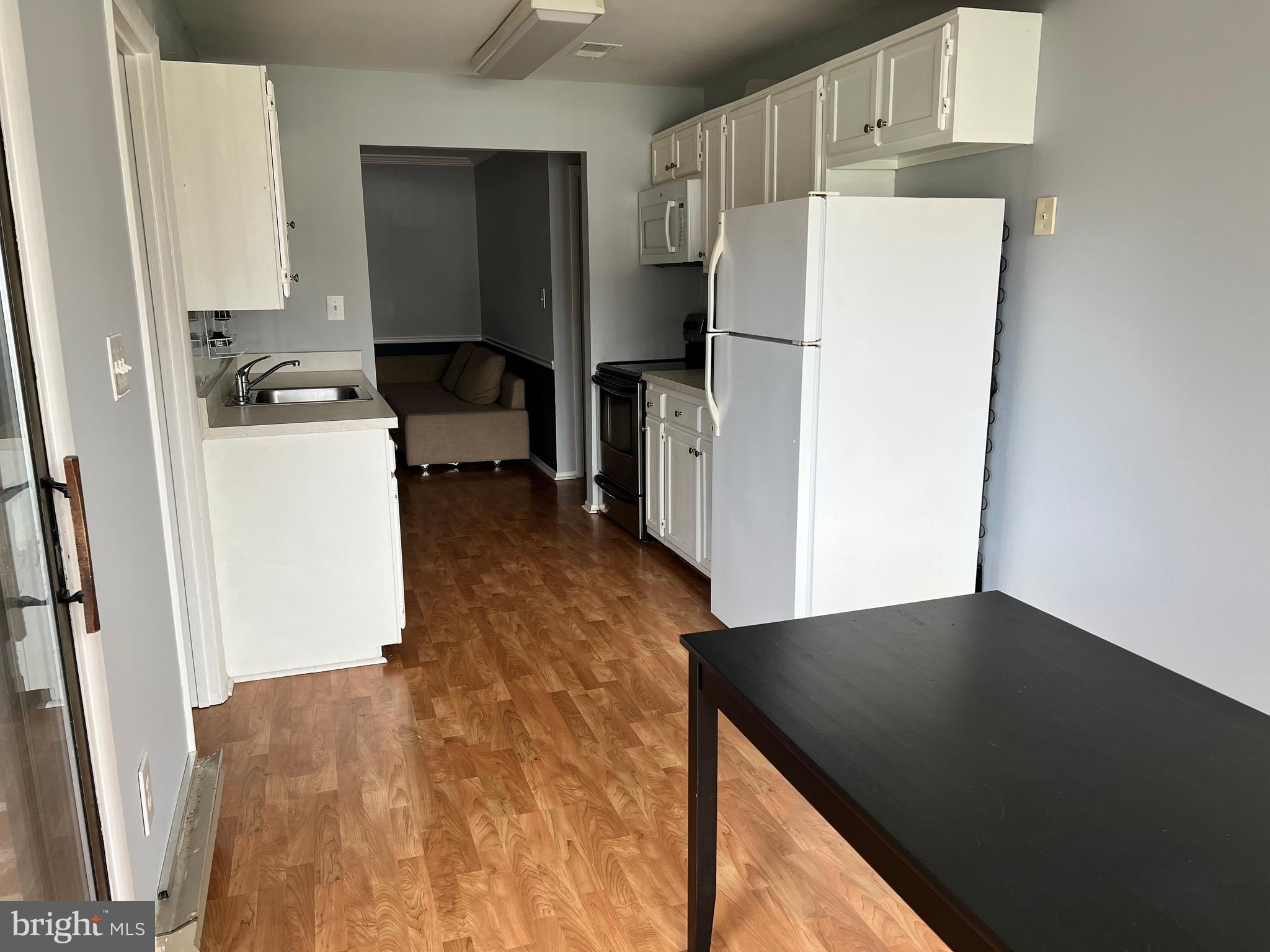 8141 Needwood Road, Unit 104 Derwood, MD 20855 - Photo 12 of 42 a kitchen with a refrigerator and a stove